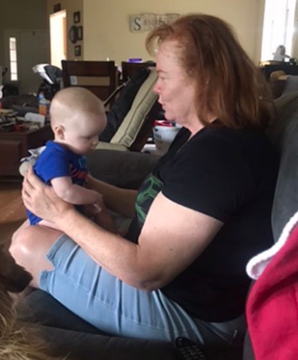 Sandy playing with a baby at home
